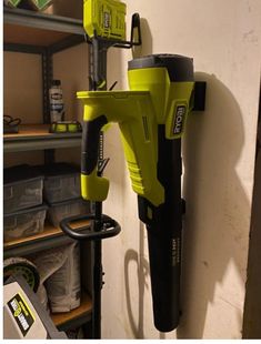 a cordless driller mounted on the wall next to shelves in a storage room