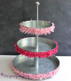 three tiered cake stand with pink flowers on it