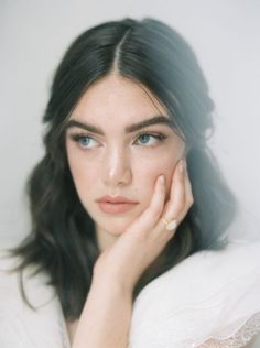 a woman with blue eyes wearing a ring