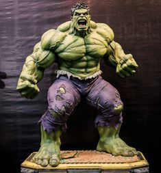 the hulk statue is displayed in front of a black background