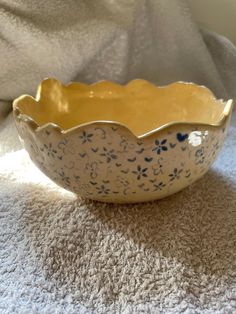 a blue and white bowl sitting on top of a carpet