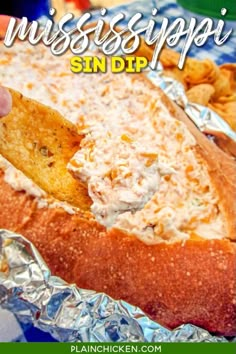 a person dipping chips into a sandwich on tin foil with the words mississippi sin dp