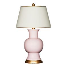 a pink table lamp with a white shade on the top and gold trim around the base