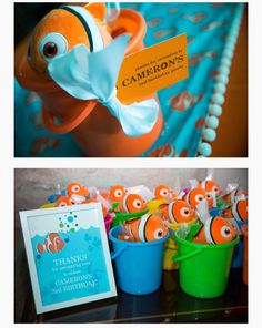 an orange and blue fish themed birthday party with candy in buckets on the table