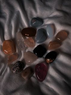 several different colored rocks laying on top of a white sheet