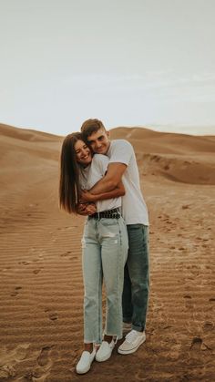 a man and woman hugging in the desert