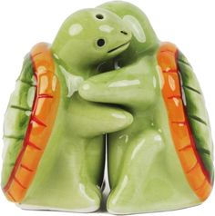 two ceramic figurines are hugging each other