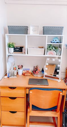 a wooden desk with two drawers and a laptop on it