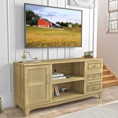 a large flat screen tv mounted to the side of a wooden entertainment center in a living room