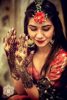 a woman with her hands covered in henna