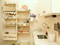 there are two shelves in the kitchen with pots and pans on them