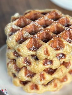 a stack of waffles sitting on top of a white plate