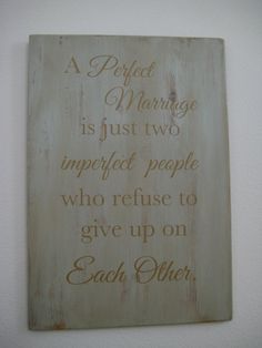 a wooden sign that says, a perfect marriage is just two imperfect people who refuse to give up on each other