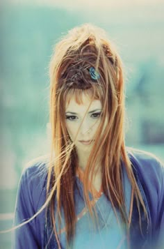 a woman with long hair and blue shirt