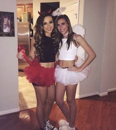 two women dressed up in costumes posing for the camera