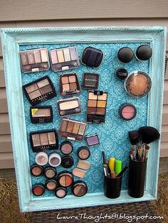 a shadow box filled with makeup and other items