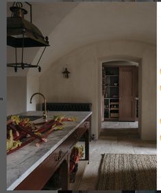 a kitchen with an archway leading to another room