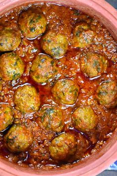 some meatballs are in a red pot