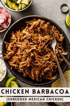 shredded mexican chicken in a skillet with limes and cilantro on the side