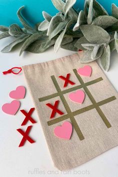 a tic - tac - toe board with hearts cut out on it