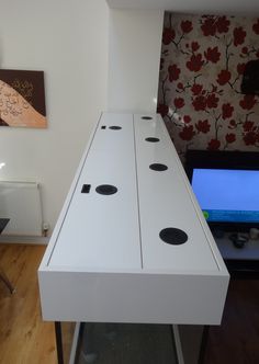 a white table with four black dots on it