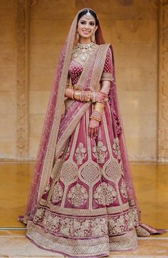 a woman in a red and gold bridal gown