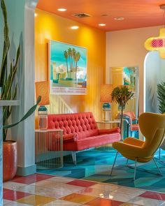 a brightly colored living room with chairs and plants