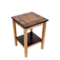 a small wooden table with black and brown tile on it's top, against a white background