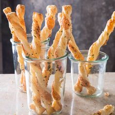 small glass cups filled with cheesy bread sticks