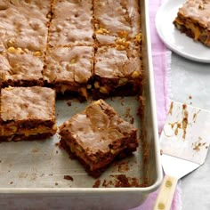 a pan filled with brownies sitting on top of a table