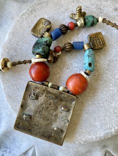 Ethnographic Antique Amulet Prayer Box Glass Brass Mixed Stone Turquoise Wood Trbal Bead Necklace measures 22 inches around weighs 3.4 oz. Bohemian Rectangular Beaded Necklaces, Traditional Rectangular Necklace For Festivals, Traditional Adjustable Rectangular Necklaces, Traditional Adjustable Rectangular Necklace, Traditional Rectangular Jewelry With Colorful Beads, Artisan Bronze Jewelry With Polished Beads, Bohemian Jewelry With Large Rectangular Beads, Bohemian Rectangular Beaded Necklaces For Gifts, Bohemian Multicolor Rectangular Jewelry