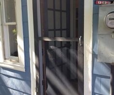 a blue house with a screen door