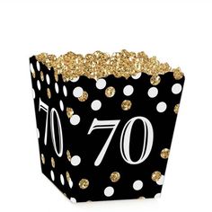 a black and gold 70th birthday treat box with white polka dots on the side,