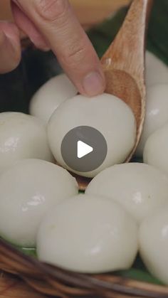 a person is spooning some food out of a basket