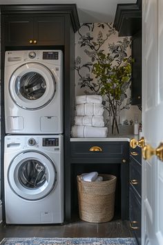 a washer and dryer in a small room with wallpaper on the walls