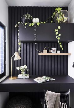 a black desk with some plants on it