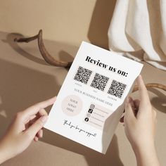 a person holding up a book with qr code on it