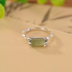 The Serenity Jade Sterling Silver Ring is an exquisite piece, showcasing a 10mm wide and 5mm tall serene jade stone as its centerpiece. Crafted from high-quality S925 sterling silver, this ring offers both elegance and durability. Weighing approximately 2 grams, it features a refined band design with a 2mm thickness, providing a comfortable fit. The ring's inner circumference ranges from 54 to 60mm, accommodating various finger sizes. Due to lighting and display differences, the actual product color may slightly vary, adding to the uniqueness of each piece. This ring embodies sophistication and timeless style. Band Design, Pearl Jewelry Necklace, Natural Stones Necklace, Gold Statement Earrings, Natural Stone Jewelry, Natural Stone Bracelets, Jade Stone, Anklet Jewelry, Pearl Ring