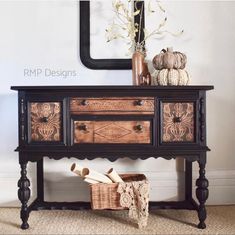 a black and brown dresser sitting next to a wall with a mirror on it's side