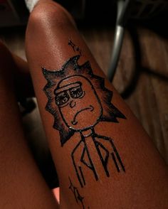 a person with a tattoo on their leg that has a cartoon character drawn on it