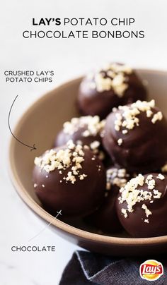 chocolate covered doughnuts with white sprinkles on top in a bowl