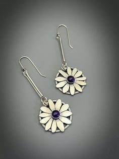 "Sterling silver flower earrings with Purple Amethyst  gemstones. They are made one at a time so each flower is slightly different Sterling silver ear wires. The length of these earrings from the top is 2.7\" The width at the widest point is 1\" These are light to wear. If they're not comfortable on me I won't sell them. Sterling silver setting. 6mm Purple Amethyst  My signature and .925 are on the piece. All my pieces are 100% handmade by me. Each box jewelry is packaged has a special painting Purple Sterling Silver Jewelry With Flower Charm, Sterling Silver Jewelry With Purple Flower Charm, Elegant Sterling Silver Earrings With Flower Pendant, Sterling Silver Flower-shaped Jewelry With Matching Earrings, Elegant Sterling Silver Flower Pendant Earrings, Purple Sterling Silver Flower-shaped Jewelry, Flower Shaped Gemstone Earrings As Gift, Purple Sterling Silver Flower Pendant Jewelry, Handmade Sterling Silver Flower Earrings