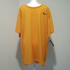 This Nike Orange Dri-Fit Short Sleeve T-Shirt Features Pullover, Crew Neck, Short Sleeves, Side Slits, And Front Nike Swoosh. Rock This T-Shirt With Any Of Your Wardrobe Pieces! Yellow V-neck Top For Loungewear, Nike Sporty T-shirt For Loungewear, Nike Cotton T-shirt For Loungewear, Oversized Nike Cotton T-shirt, Nike Sporty Tops For Loungewear, Casual Yellow T-shirt For Loungewear, Nike Casual V-neck Top, Nike Short Sleeve Relaxed Fit Shirt, Nike Relaxed Fit Short Sleeve Shirt