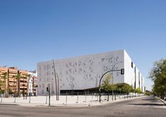 a large white building sitting on the side of a road