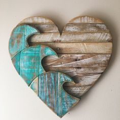 a wooden heart with two pieces cut out of it and painted blue on the inside