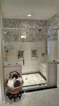 a bathroom with a walk in shower next to a sink