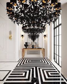 a black and white floor with a chandelier hanging from it's ceiling