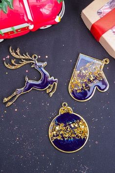 three christmas ornaments sitting on top of a table