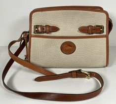 This is a gorgeous, very rare, vintage Dooney & Bourke All Weather Leather cross body Hand Bag in Beige and tan brown. The bag is in excellent condition with minimal normal signs of wear. It is overall clean and in amazing shape! Refer to the photos for full cosmetic details. The bag is made in the USA. Leather Cross, Hand Bag, Dooney Bourke, Tan Brown, Very Rare, Leather Crossbody, Cross Body, Signs, Handbags