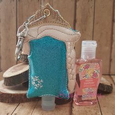 a small purse with a bottle next to it on top of a wooden table near a piece of wood